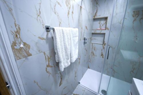 a bathroom with a shower and a white towel at Cozy Charming Bungalow BRAND NEW in Preston