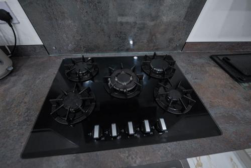 a stove top with four burners on a counter at Cozy Charming Bungalow BRAND NEW in Preston