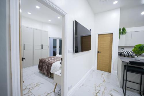 a bedroom with a bed and a door leading to a bathroom at Cozy Charming Bungalow BRAND NEW in Preston