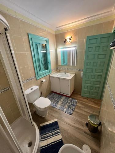 a bathroom with a toilet and a sink and a mirror at Casas de Valtravieso El Aljibe in El Pozo de los Frailes
