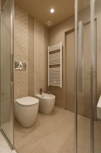 a bathroom with a toilet and a sink at La Rotta Rooms in Agrigento
