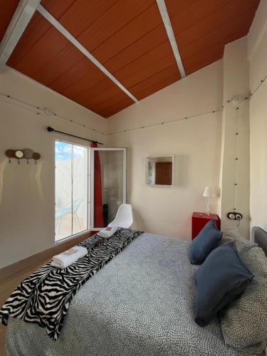 a bedroom with a large bed with a zebra blanket at Guesthouse Jazmínes Mozárabes # WIFI in Baena
