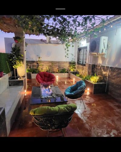 a living room with a table and chairs in a room at Large two story house in Le Hamiz