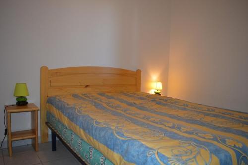 une chambre avec un lit et une lampe sur une table dans l'établissement SAINT CYPRIEN - Appartement 3 PIECES 6 Personnes SC060-106A, à Saint Cyprien Plage