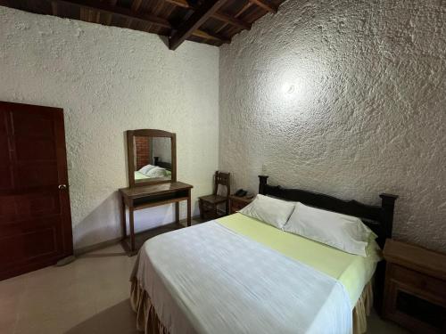 Ένα ή περισσότερα κρεβάτια σε δωμάτιο στο Hotel Campestre UMPALÁ