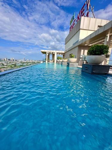 a pool on the roof of a building with blue water at New Private Turkish Luxe Jacuzzi Studio in Gurgaon
