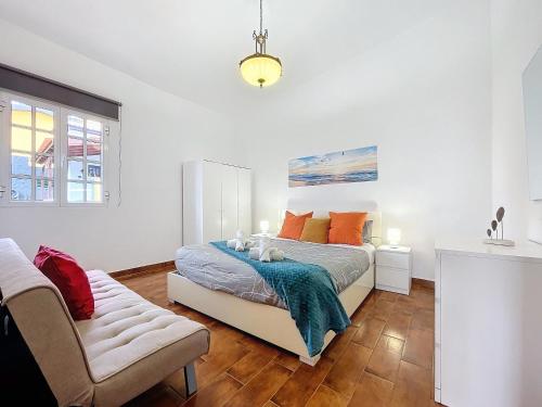 a bedroom with a bed and a couch at Casa Moreira by AH in Caniçal