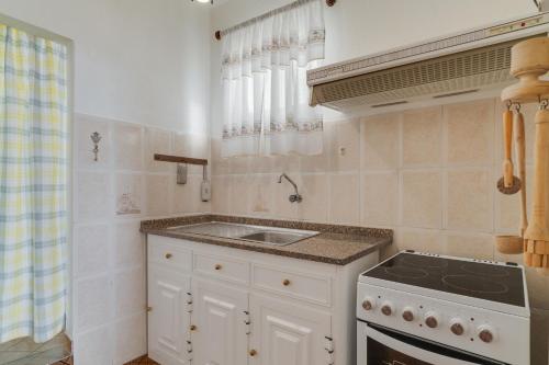 a kitchen with a sink and a stove at Casa Moreira by AH in Caniçal