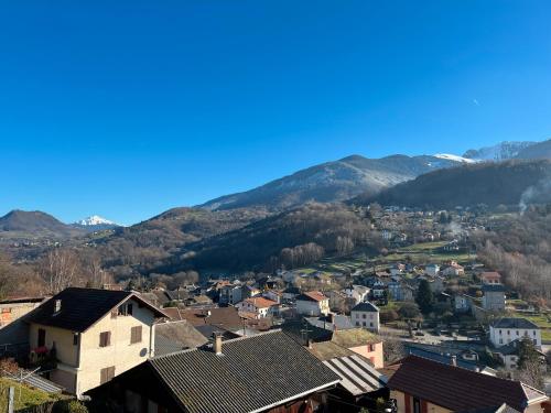 a small town with mountains in the background at Logis Les Forges in Arvillard