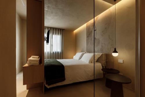 a bedroom with a bed and a glass wall at La Rotta Rooms in Agrigento
