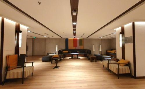 a large room with couches and tables in a building at Apec Mandala Romantic Mui Ne in Ấp Thiẹn Ái