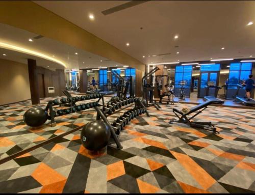 a gym with rows of treadmills and machines at Apec Mandala Romantic Mui Ne in Ấp Thiẹn Ái