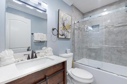 a bathroom with a sink and a toilet and a shower at The Irons #3 in Pigeon Forge
