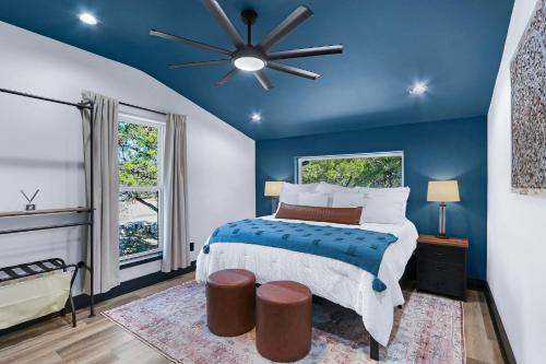 a blue bedroom with a bed and a ceiling fan at Little Blanca in Canyon Lake