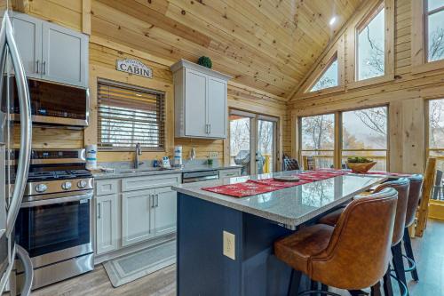 a kitchen with a large island in a wooden cabin at Bear's Hideaway in Sevierville