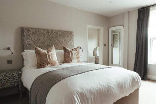 a bedroom with a large bed with white sheets and pillows at The Goudhurst Inn in Goudhurst