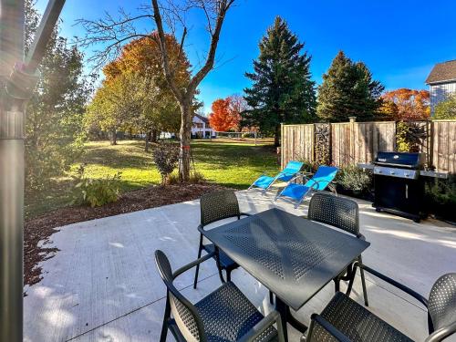 a patio with a table and chairs and a grill at Hike BIke Chill in Collingwood