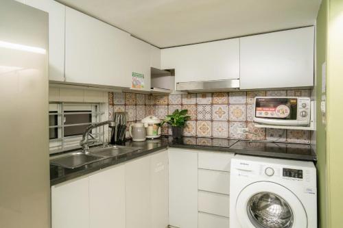 a kitchen with a washing machine and a sink at Old Quarter 6 Senses 3Br Hoan Kiem in Hanoi