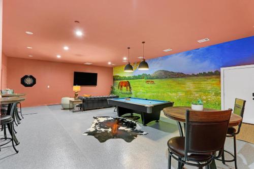a room with a pool table and a mural at Hidden Hills in Fischer