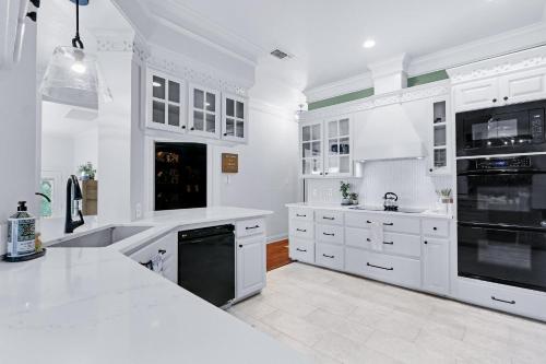 a large white kitchen with white cabinets and appliances at Hidden Hills in Fischer