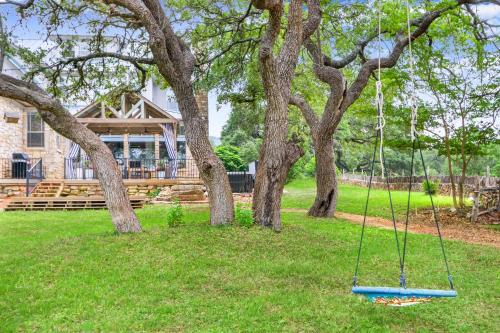 a swing in the grass in front of a house at Hidden Hills in Fischer