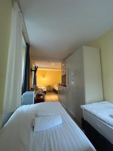 a hotel room with two beds and a living room at Gasthaus 210 in Zürich