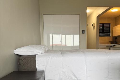 a white bed in a room with a window at Ridge Royal in Amanzimtoti