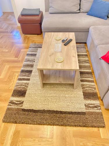 a living room with a couch and a coffee table at Apartment Riverside in Novi Beograd