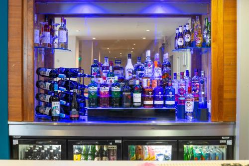 a bar filled with lots of bottles of alcohol at Holiday Inn Express Stevenage by IHG in Stevenage