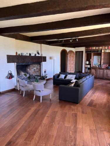 a living room with a couch and a fireplace at TEROTERO Lake Hostel - Habitación Gutiérrez in San Carlos de Bariloche
