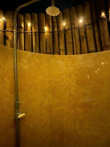 a large yellow wall in a wine cellar at night at BOHO Glamping - CẮM TRẠI HỒ TRỊ AN in Ấp Phú Cát