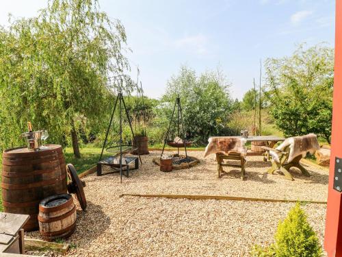 two animals in a playground with a table and swings at Bonnie's Shepherds Hut at Shepherds Lodge Retreat and Wellness in Nottingham