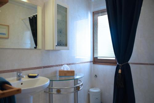 a bathroom with a sink and a mirror at Hacienda Cabreras in Villena