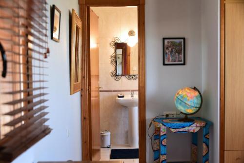 a hallway with a bathroom with a sink and a mirror at Hacienda Cabreras in Villena