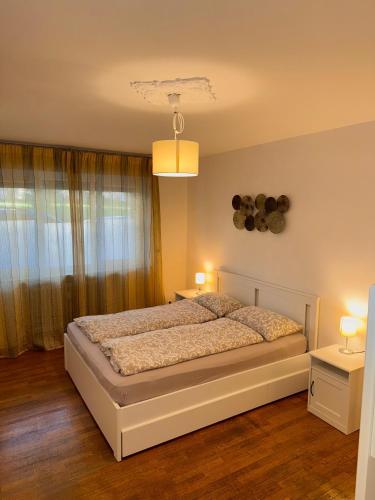 a bedroom with a bed with two tables and two lamps at Friedrich Apartments in Merano