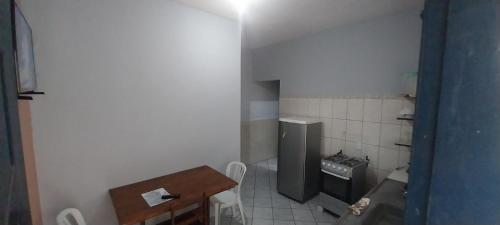 a small bathroom with a sink and a refrigerator at Apartamento Ilha comprida centro in Ilha Comprida