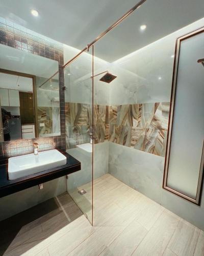 a bathroom with a sink and a mirror at Luxe 2 BHK with Stunning Views in Gurgaon