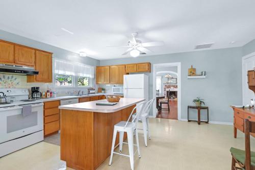 a kitchen with wooden cabinets and white appliances at Revival DSTX LLC - Bed & Breakfast in Dripping Springs