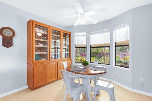 a dining room with a table and chairs and a ceiling fan at Revival DSTX LLC - Bed & Breakfast in Dripping Springs