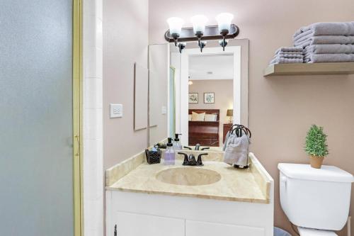 a bathroom with a sink and a mirror at Revival DSTX LLC - Bed & Breakfast in Dripping Springs