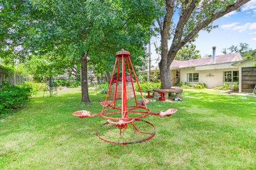a red playground in a yard with a picnic table at Revival DSTX LLC - Bed & Breakfast in Dripping Springs