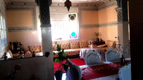 a room with a couch and a table and a window at Riad Dar Zidane in Meknès