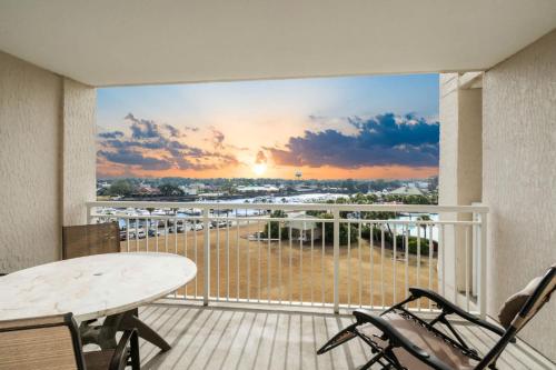 a balcony with a table and chairs and a view of a beach at Yacht Club Villas 1-505 - Marina View in Myrtle Beach