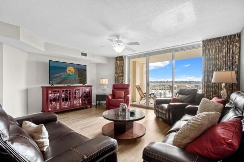 a living room with leather couches and a tv at Yacht Club Villas 1-505 - Marina View in Myrtle Beach