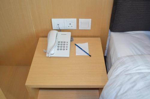 Postel nebo postele na pokoji v ubytování Q Bintang Hotel