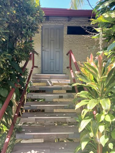 a set of stairs leading up to a door at Coyaba Tropical Elegant Adult Guesthouse in Manuel Antonio