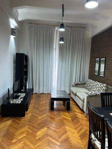 a living room with a couch and a table at Exelente alojamiento in Buenos Aires