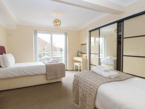 a hotel room with two beds and a desk at Reedlings in Norwich