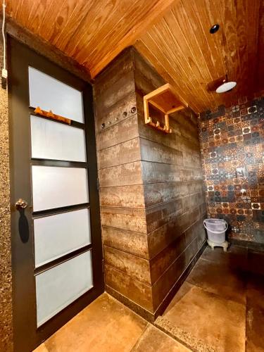 a room with a door and a brick wall at Rawai Luxury Tents Pushkar in Pushkar