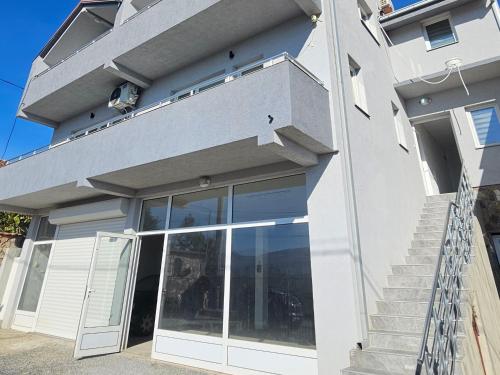 a white house with a sliding glass door at Villa Milla in Veles
